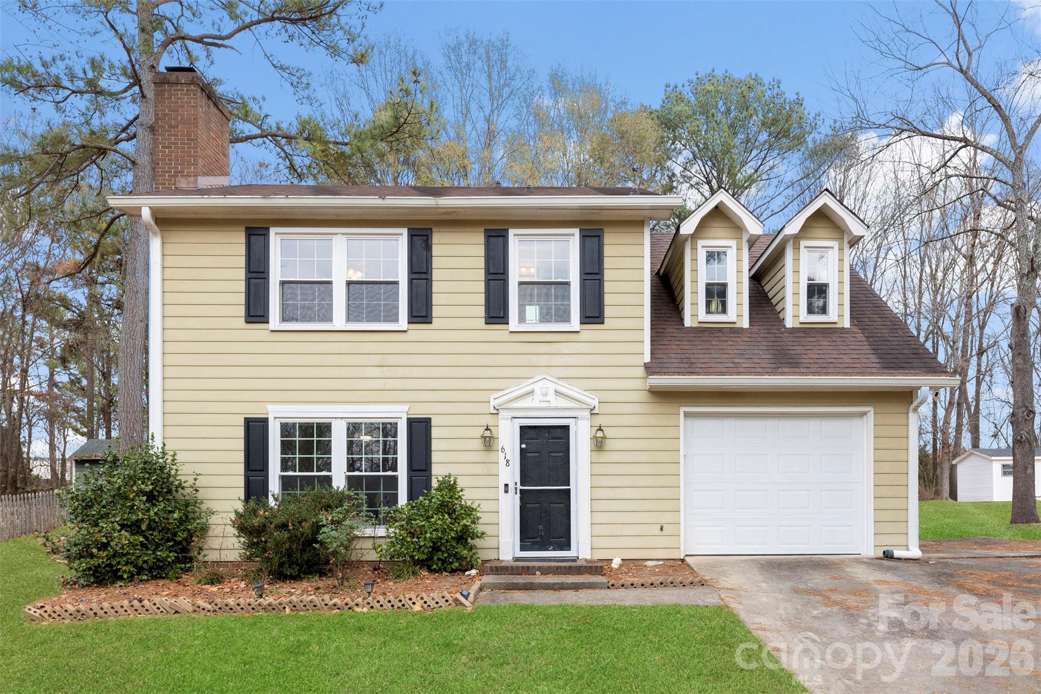 618 Tryon Place Gastonia, NC 28054 - Photo 18 of 32 a front view of a house with a garden and plants