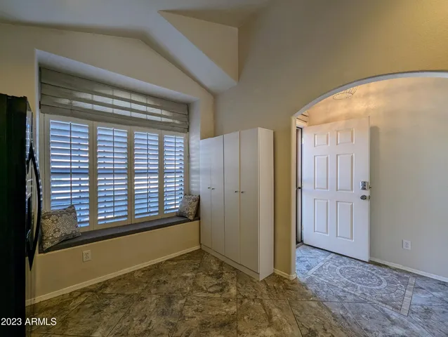 a view of a hallway with a chandelier fan and wooden floor