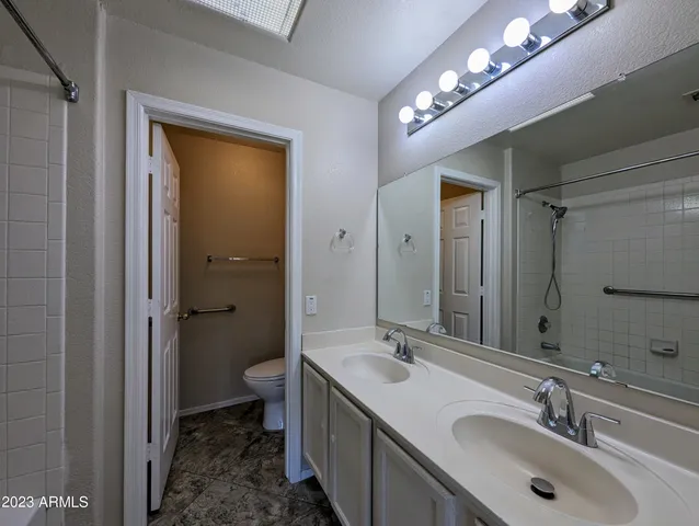 a white toilet sitting next to a bathroom sink