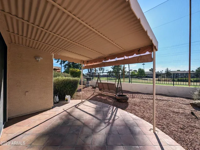 a view of a chair and tables in the patio