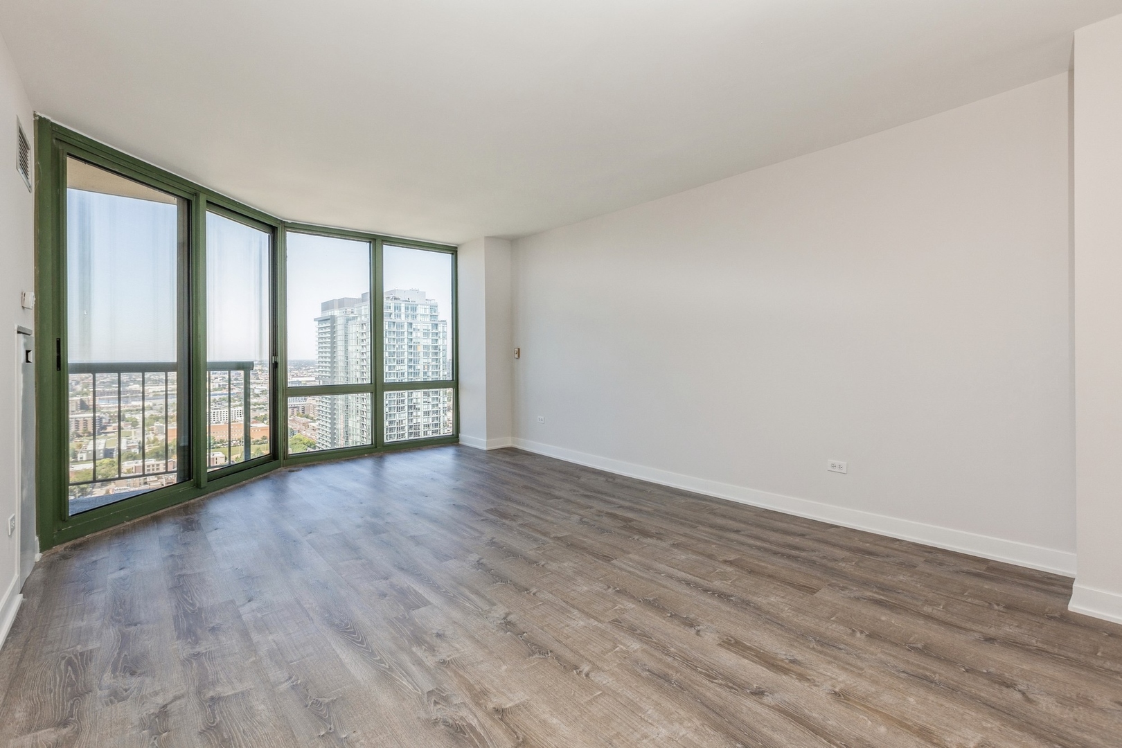 111 West Maple Street, Unit 3311 Chicago, IL 60610 - Photo 5 of 15 wooden floor in an empty room with a window