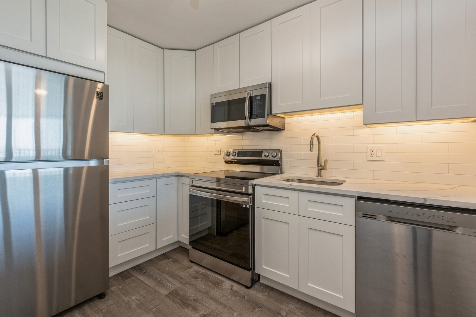 111 West Maple Street, Unit 3311 Chicago, IL 60610 - Photo 6 of 15 a kitchen with stainless steel appliances granite countertop a refrigerator sink and stove