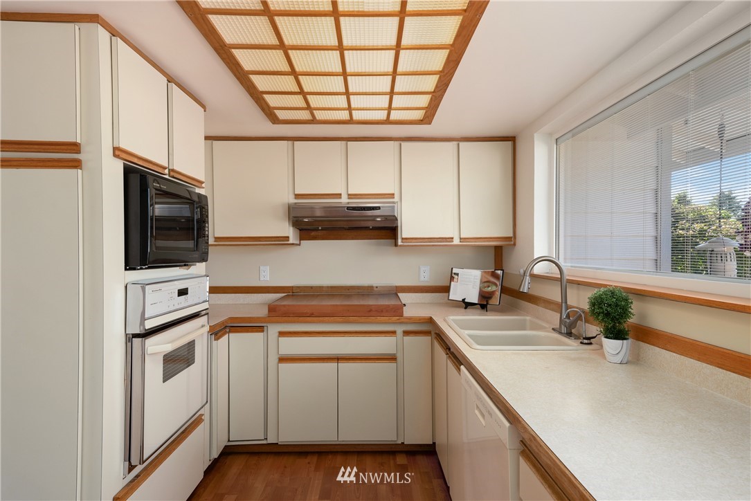 2603 171st Street Southeast Bothell, WA 98012 - Photo 11 of 37 a kitchen with stainless steel appliances granite countertop a sink a stove a microwave and cabinets