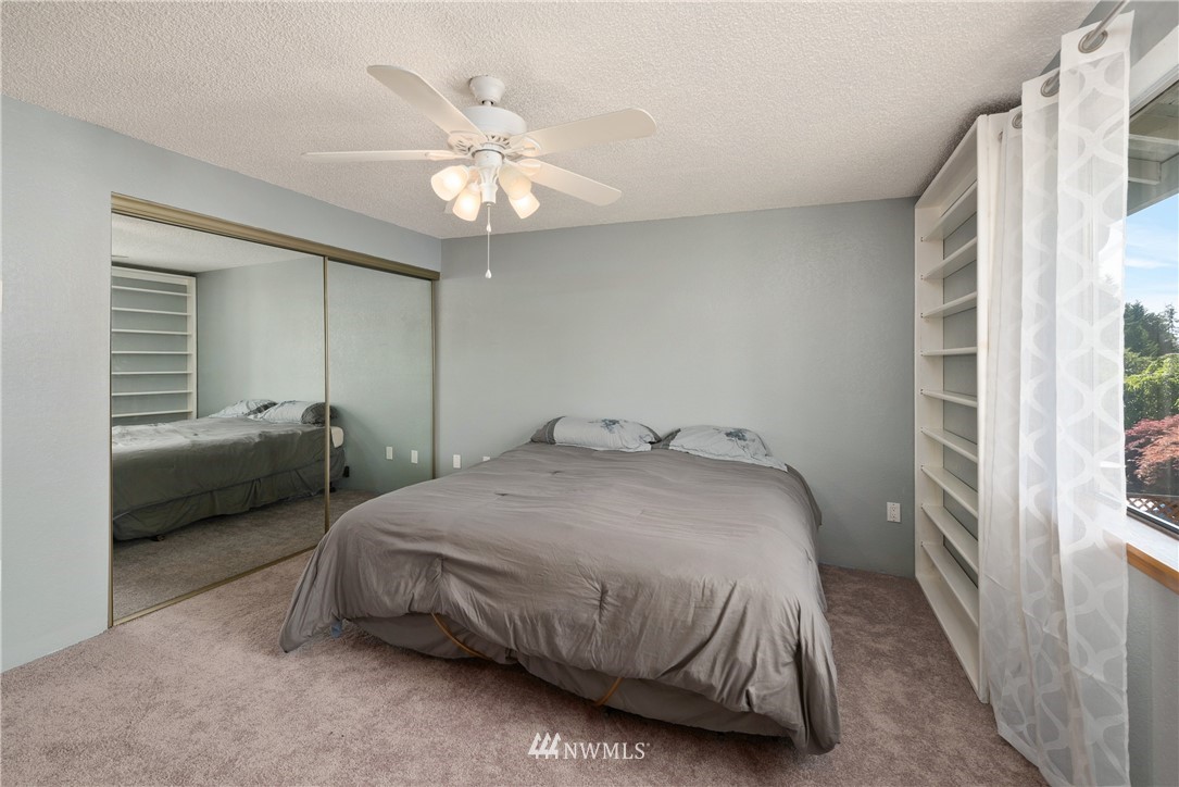 2603 171st Street Southeast Bothell, WA 98012 - Photo 19 of 37 a bedroom with a bed and a chandelier