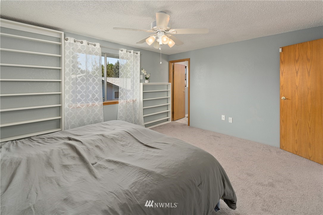 2603 171st Street Southeast Bothell, WA 98012 - Photo 20 of 37 a bedroom with a bed and a chandelier