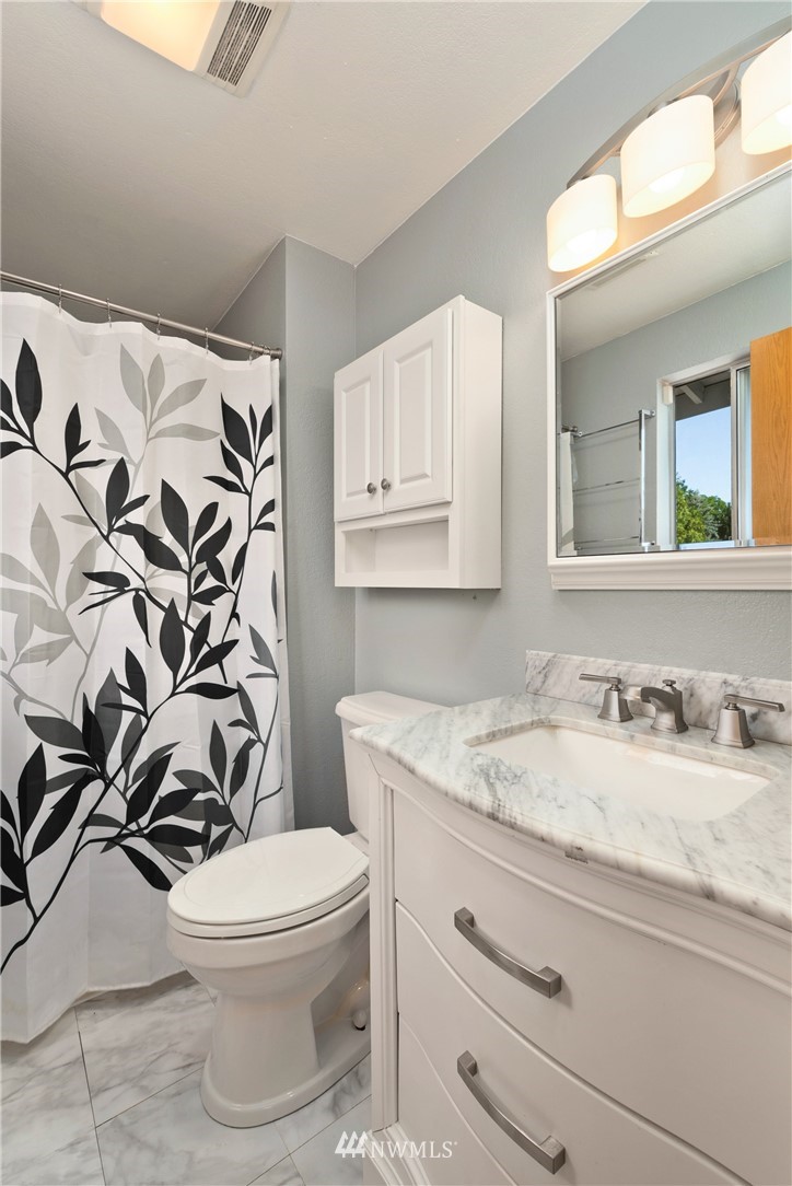 2603 171st Street Southeast Bothell, WA 98012 - Photo 21 of 37 a bathroom with a granite countertop toilet sink and mirror