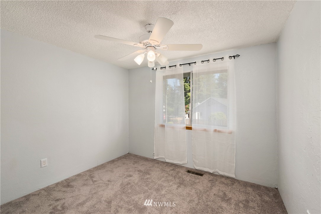 2603 171st Street Southeast Bothell, WA 98012 - Photo 23 of 37 an empty room with windows and fan