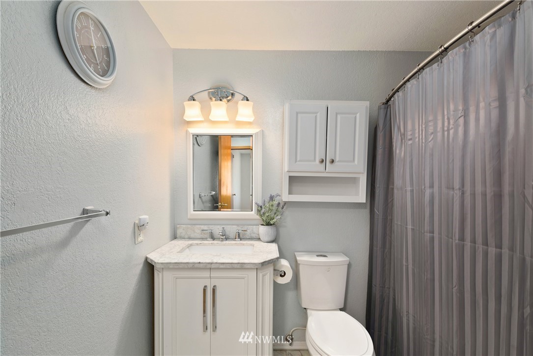 2603 171st Street Southeast Bothell, WA 98012 - Photo 24 of 37 a bathroom with a toilet a sink and a mirror
