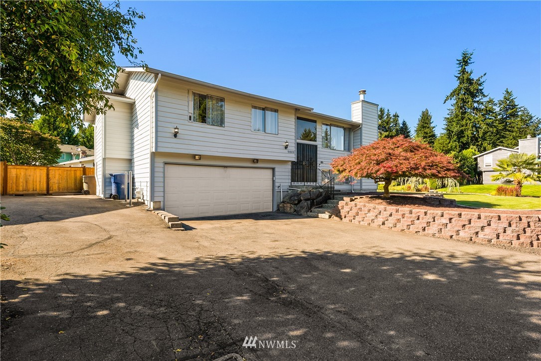 2603 171st Street Southeast Bothell, WA 98012 - Photo 4 of 37 a front view of a house with a yard and garage