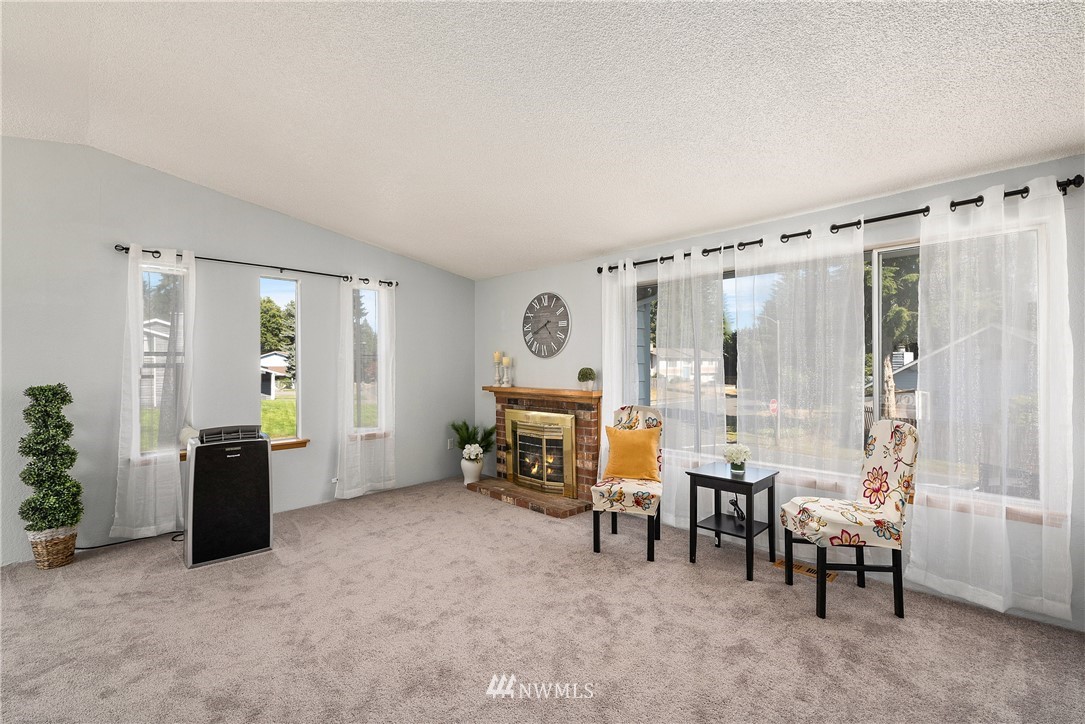 2603 171st Street Southeast Bothell, WA 98012 - Photo 5 of 37 a living room with furniture and a chandelier