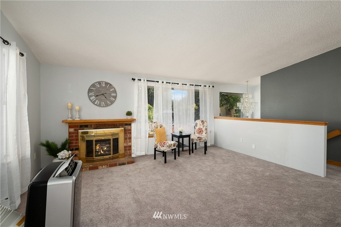 2603 171st Street Southeast Bothell, WA 98012 - Photo 9 of 37 a living room with furniture and a fireplace