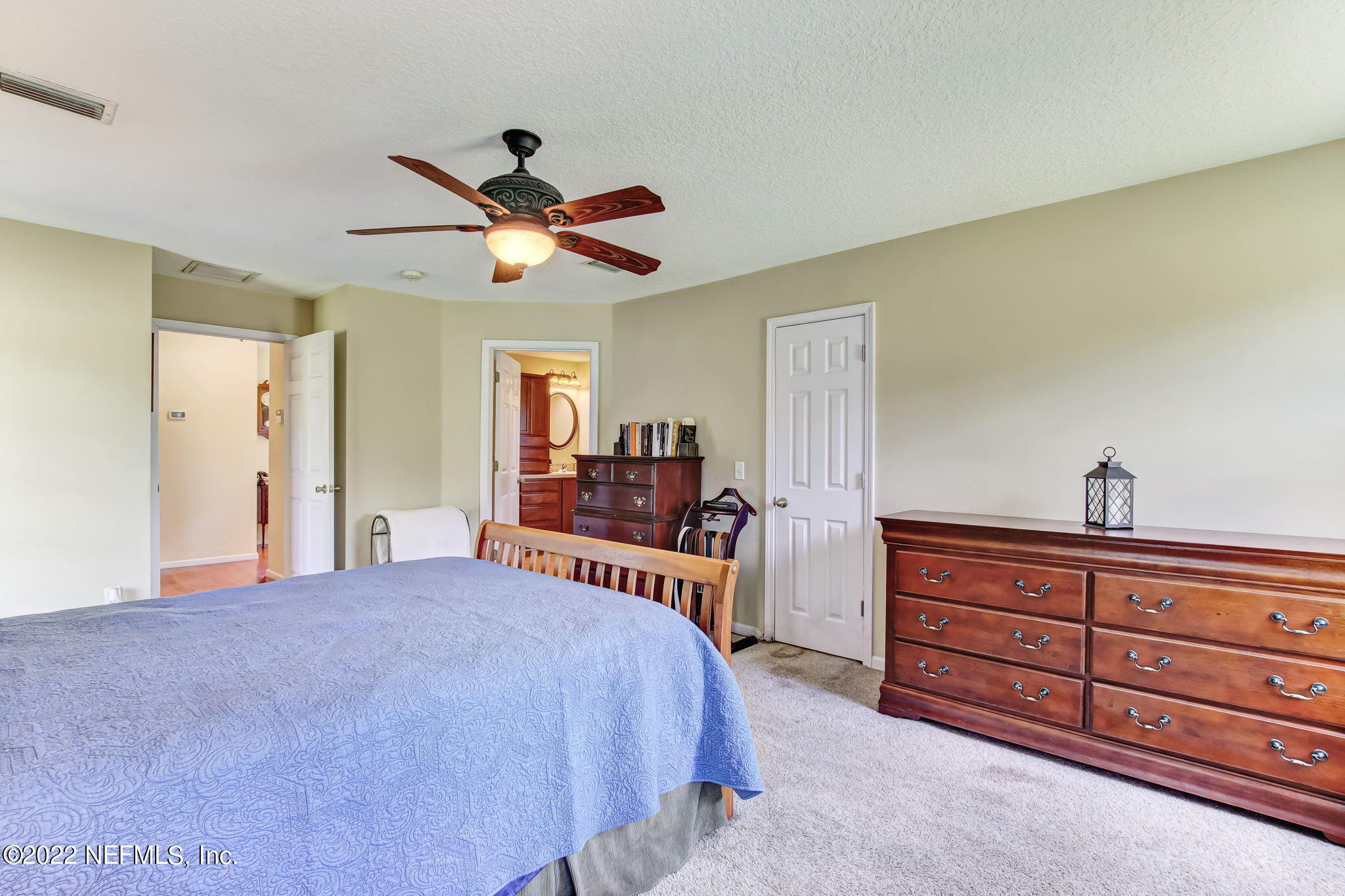 12410 County Road 121 Bryceville, FL 32009 - Photo 16 of 34 a bedroom with a bed and a chandelier