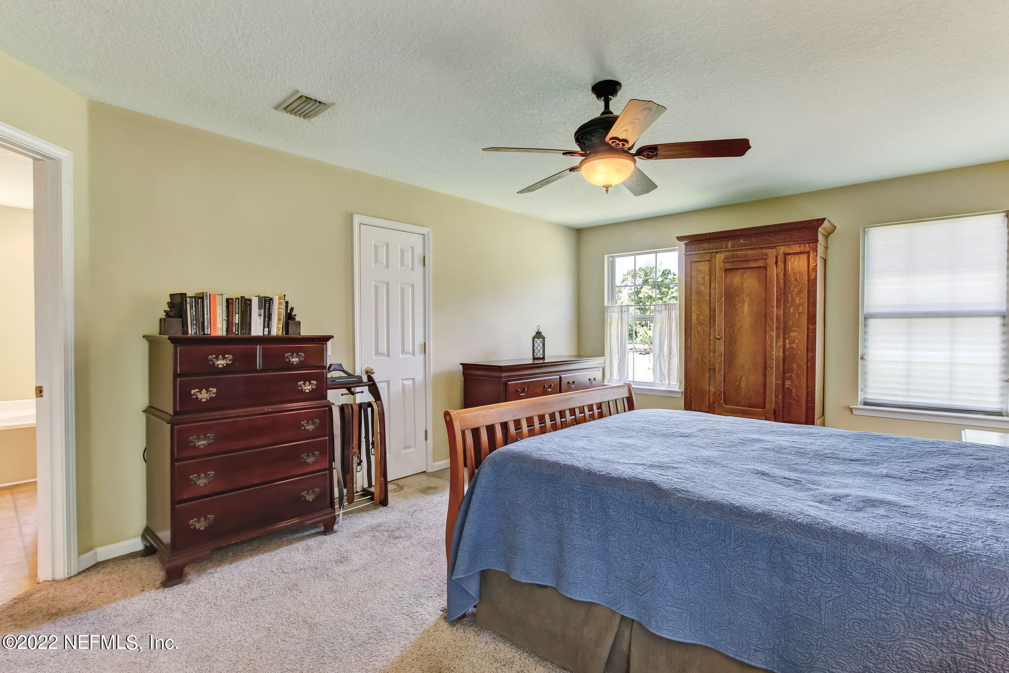 12410 County Road 121 Bryceville, FL 32009 - Photo 17 of 34 a bedroom with a bed and a chandelier