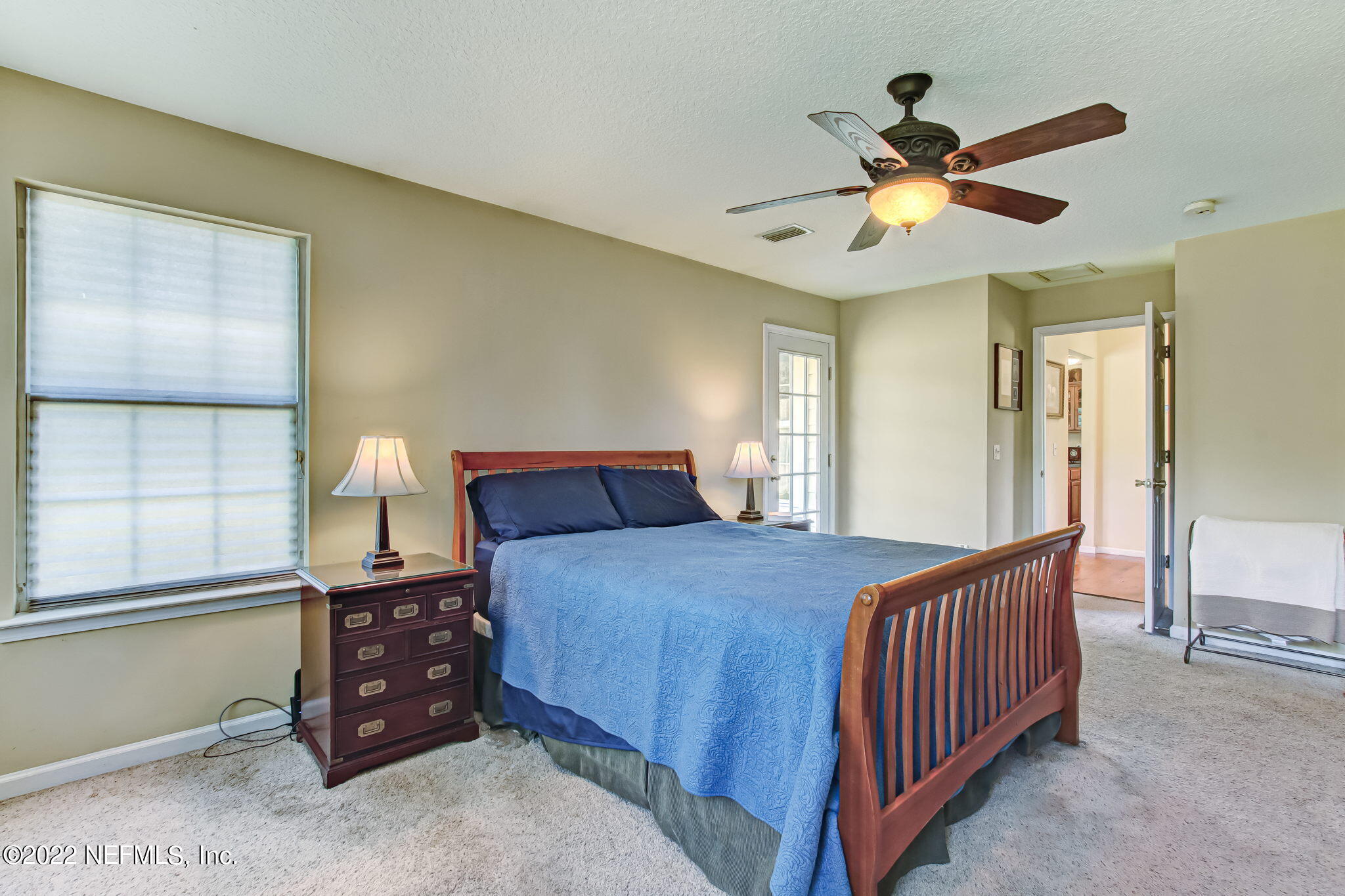 12410 County Road 121 Bryceville, FL 32009 - Photo 18 of 34 a bedroom with a bed and a chandelier