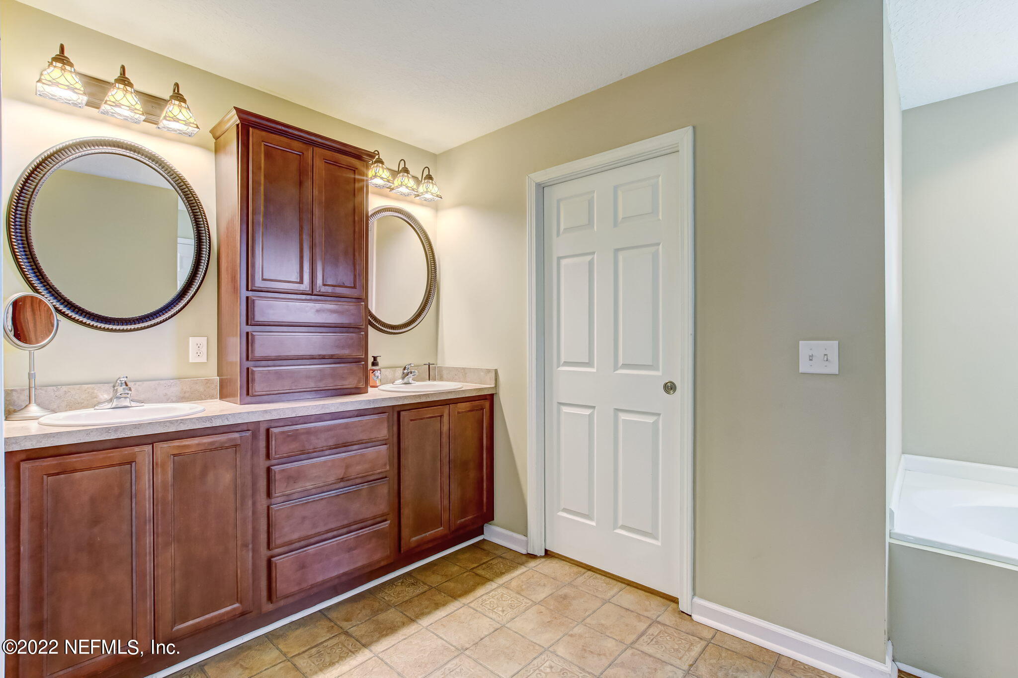12410 County Road 121 Bryceville, FL 32009 - Photo 20 of 34 a bathroom with a double vanity sink and a mirror