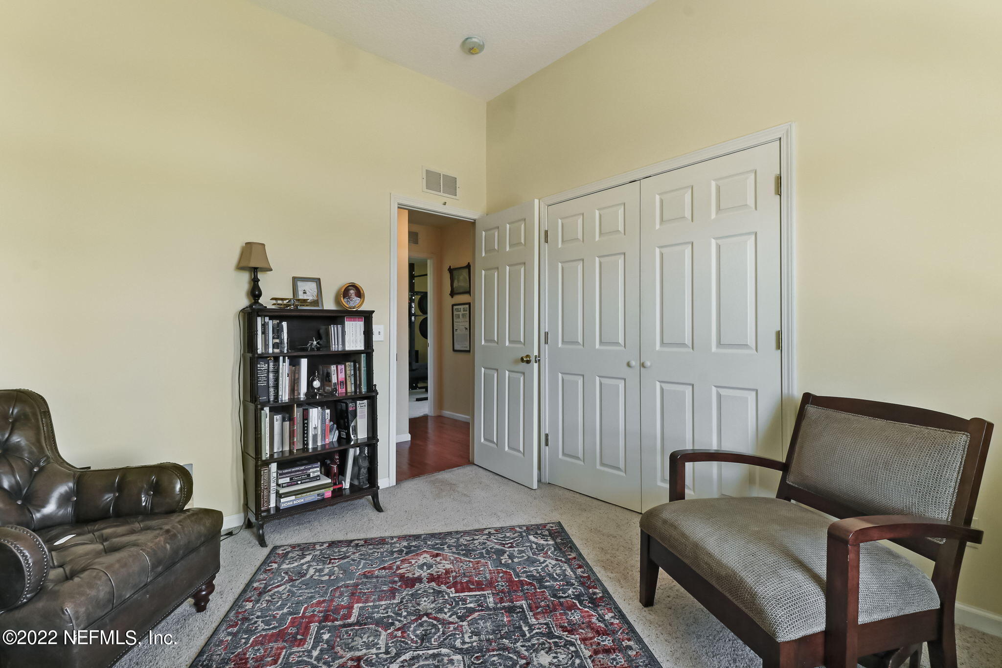 12410 County Road 121 Bryceville, FL 32009 - Photo 23 of 34 a hallway with a couch and a book shelf