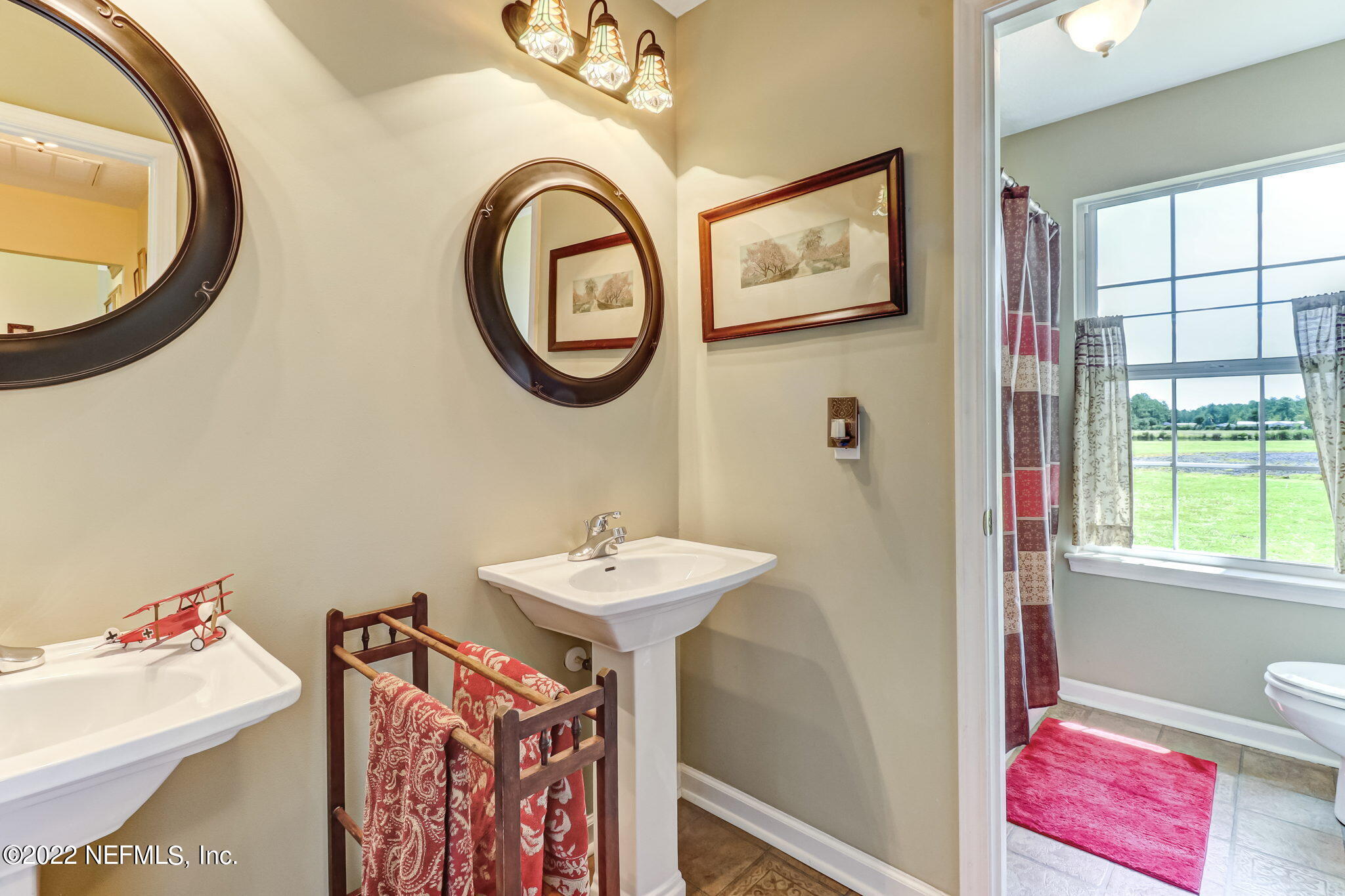 12410 County Road 121 Bryceville, FL 32009 - Photo 33 of 34 a bathroom with a sink and a mirror