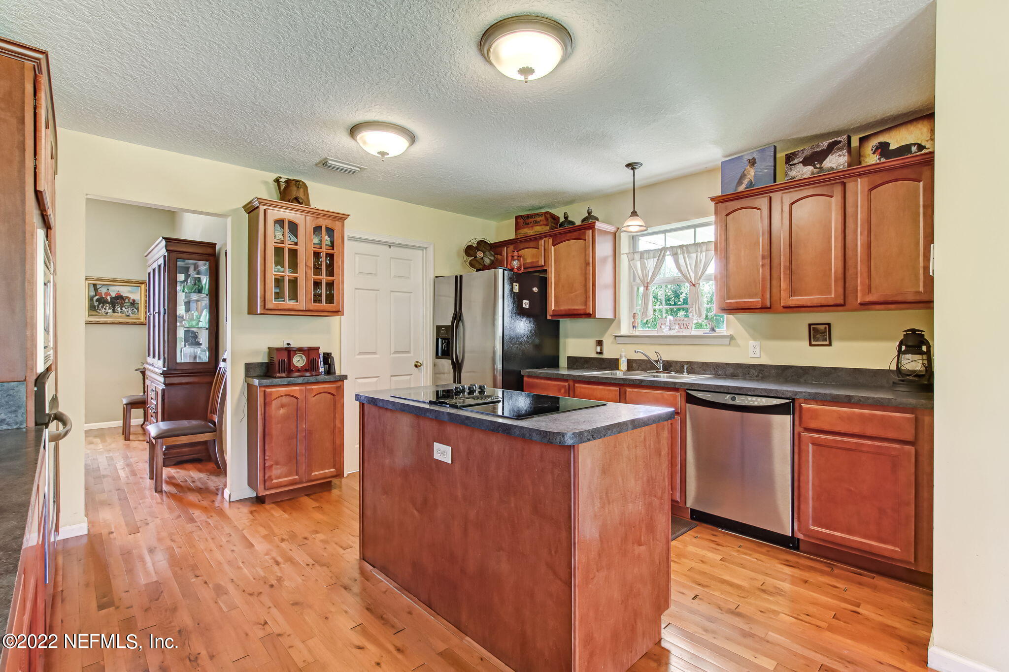 12410 County Road 121 Bryceville, FL 32009 - Photo 9 of 34 a kitchen with granite countertop a sink cabinets and wooden floor