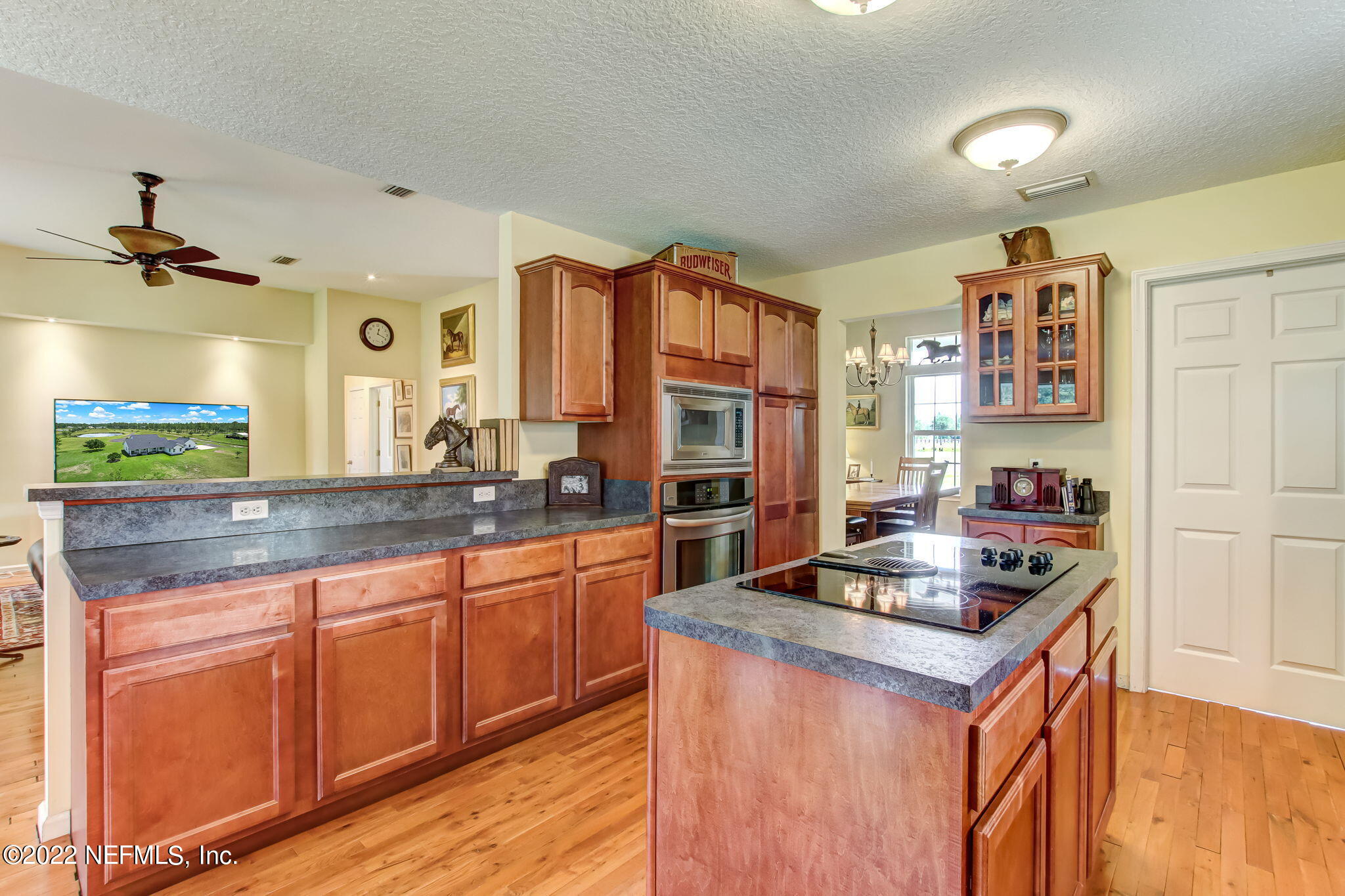 12410 County Road 121 Bryceville, FL 32009 - Photo 10 of 34 a kitchen with granite countertop a sink stove and cabinets