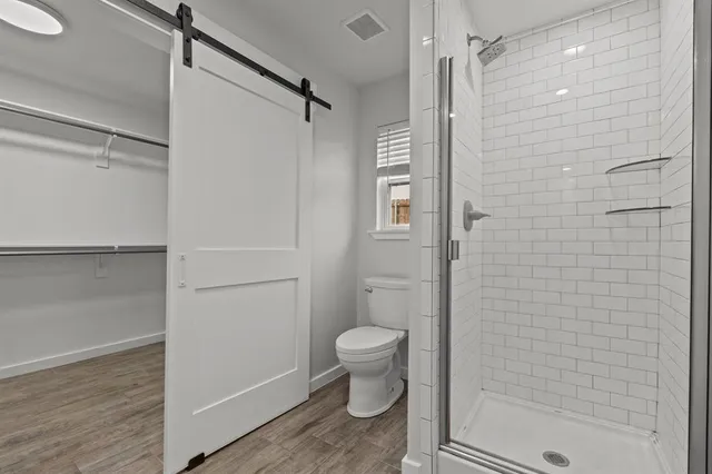 a bathroom with a shower and a toilet