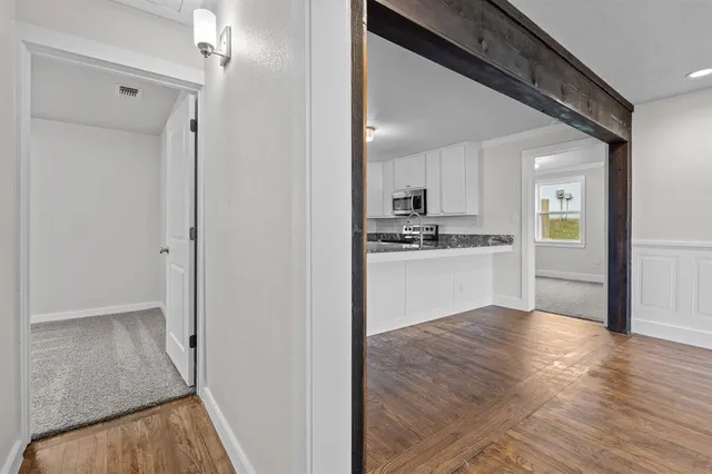 a view of a kitchen cabinets and wooden floor