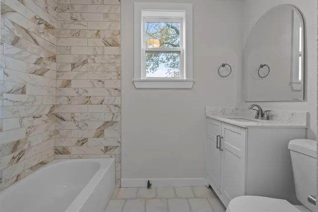 a bathroom with a sink toilet and bathtub