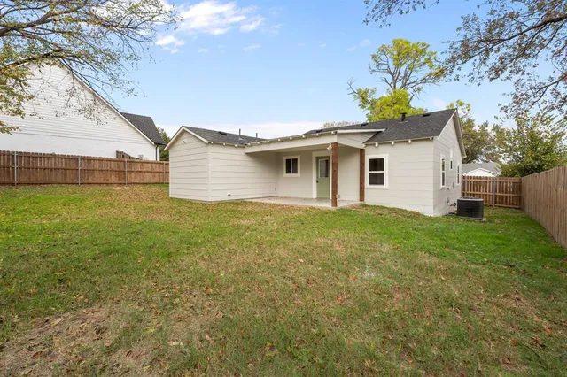 a white house that has a tree in front of it