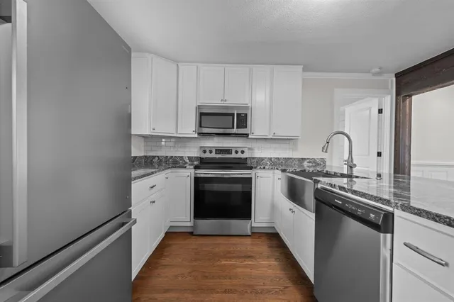 a kitchen with a sink stove and microwave