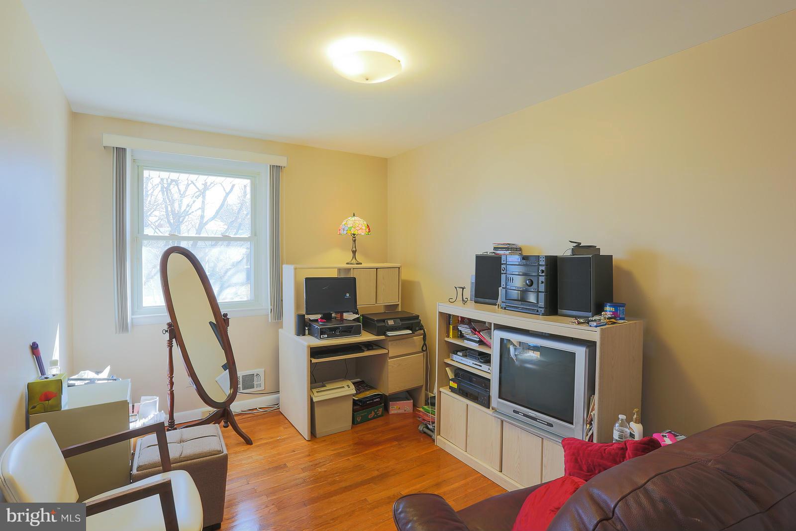 3834 Cherrybrook Road Randallstown, MD 21133 - Photo 19 of 30 a living room with furniture a fireplace and a flat screen tv