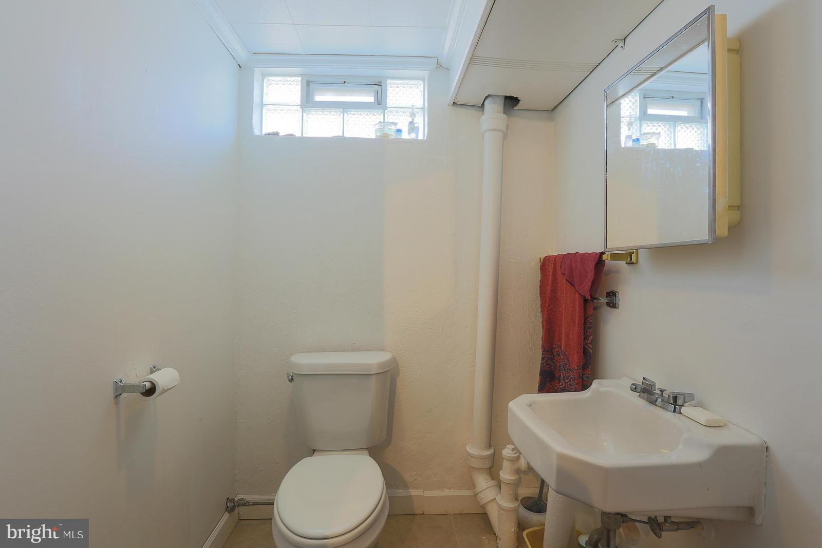 3834 Cherrybrook Road Randallstown, MD 21133 - Photo 24 of 30 a bathroom with a sink toilet and mirror