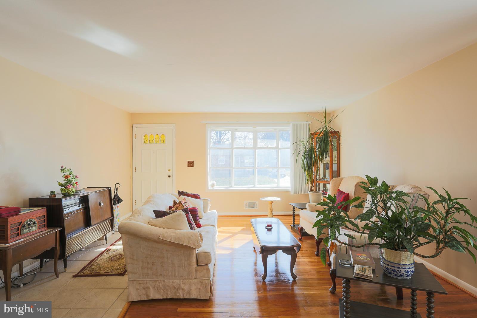 3834 Cherrybrook Road Randallstown, MD 21133 - Photo 8 of 30 a living room with furniture a potted plant and a large window