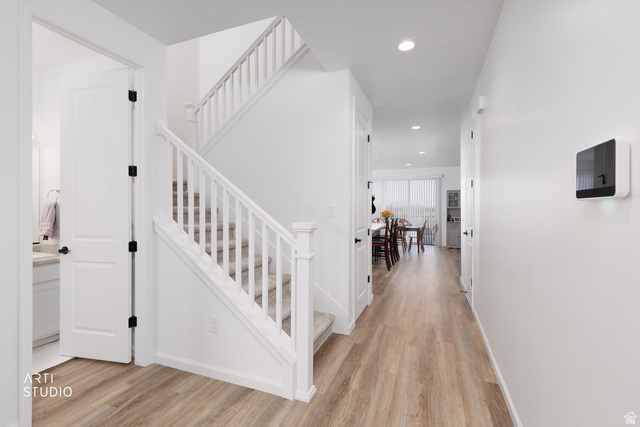540 Lefty Lane Tooele, UT 84074 - Photo 5 of 48 Stairs with wood finished floors and recessed lighting