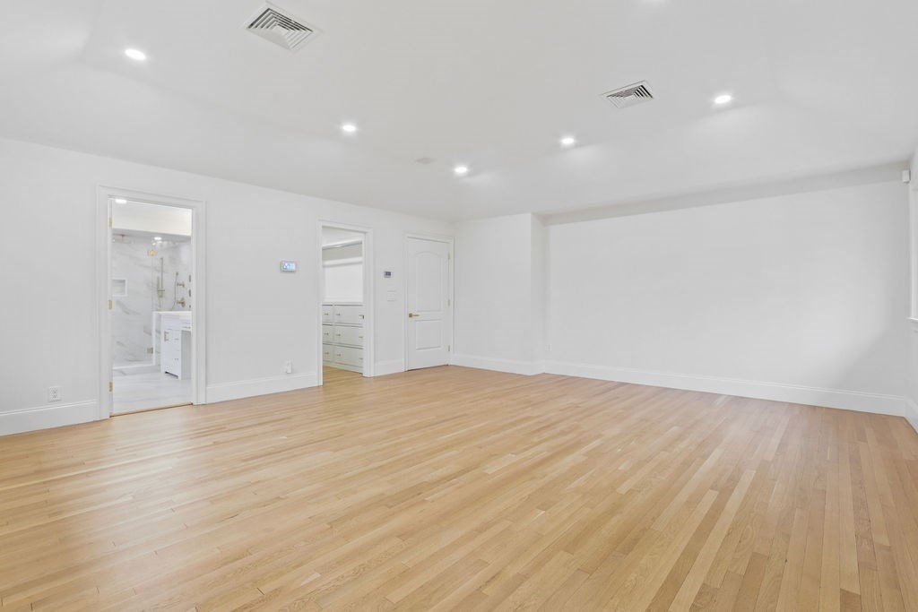 80 Doublet Hill Road Weston, MA 02493 - Photo 23 of 38 a view of an empty room with wooden floor and a window