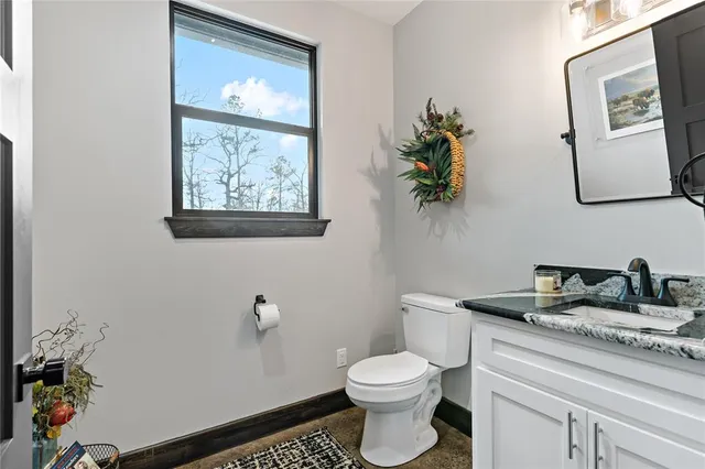 a bathroom with a toilet a sink and mirror