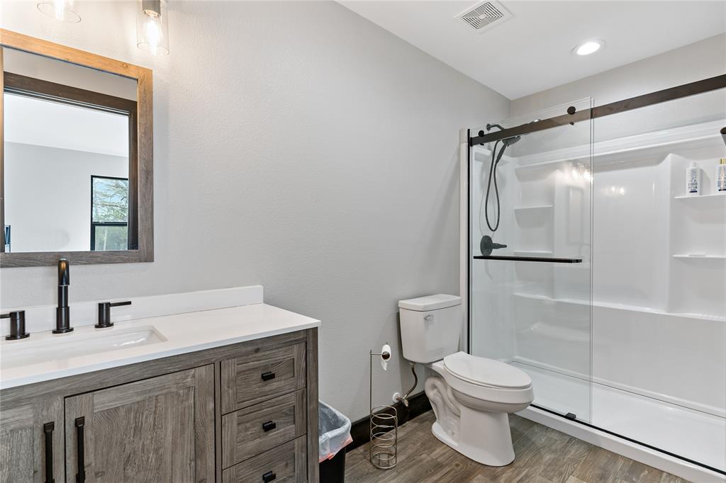 8127 Fm 910 Bogata, TX 75417 - Photo 18 of 22 a bathroom with a granite countertop sink toilet and shower