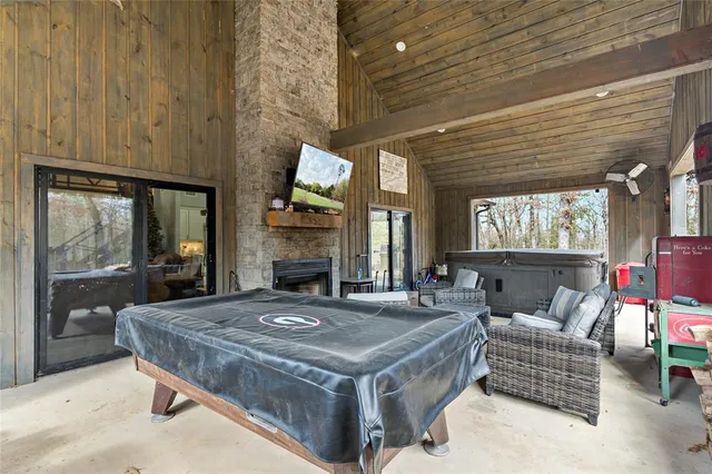 a living room with furniture a fireplace and a table