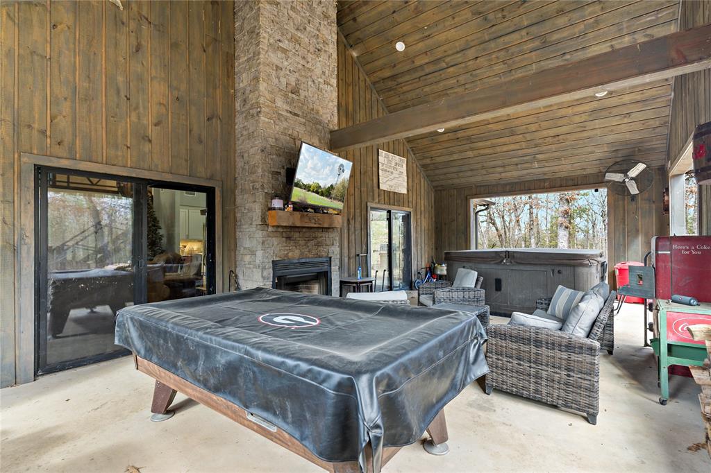 8127 Fm 910 Bogata, TX 75417 - Photo 20 of 22 a living room with furniture a fireplace and a table