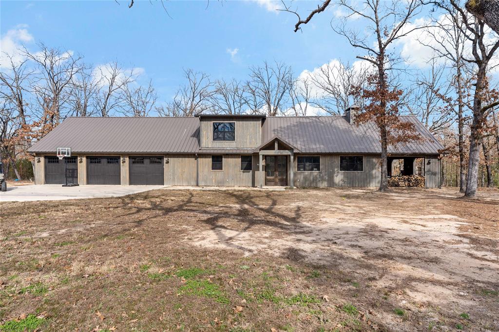 8127 Fm 910 Bogata, TX 75417 - Photo 2 of 22 a front view of a house with a yard and garage
