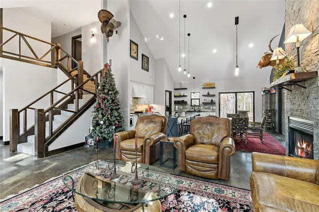 a living room with furniture or dining table and a chandelier