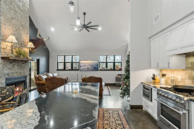 a kitchen with furniture and a fireplace