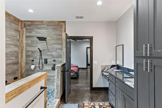 a kitchen with stainless steel appliances granite countertop a stove a sink and a refrigerator