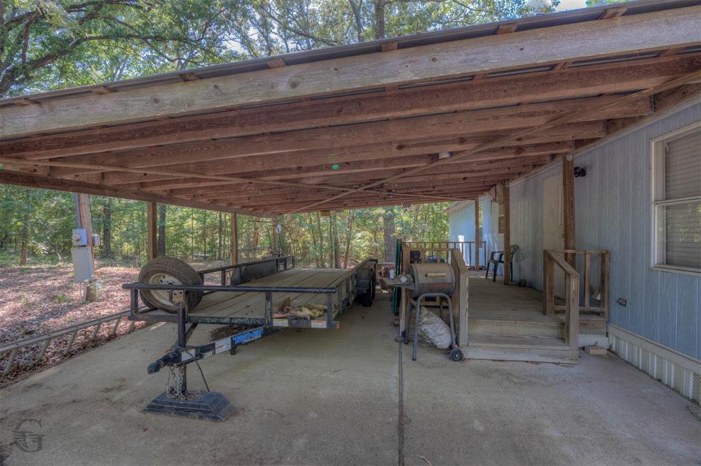 8839 Sebastian Road Keithville, LA 71047 - Photo 26 of 40 Covered carport with wood-frame construction and concrete flooring