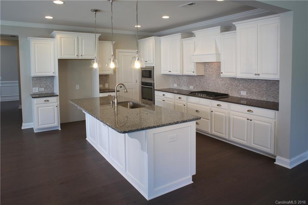132 Helton Lane, Unit 38 Fort Mill, SC 29708 - Photo 2 of 23 a kitchen with stainless steel appliances granite countertop a sink a stove and a refrigerator