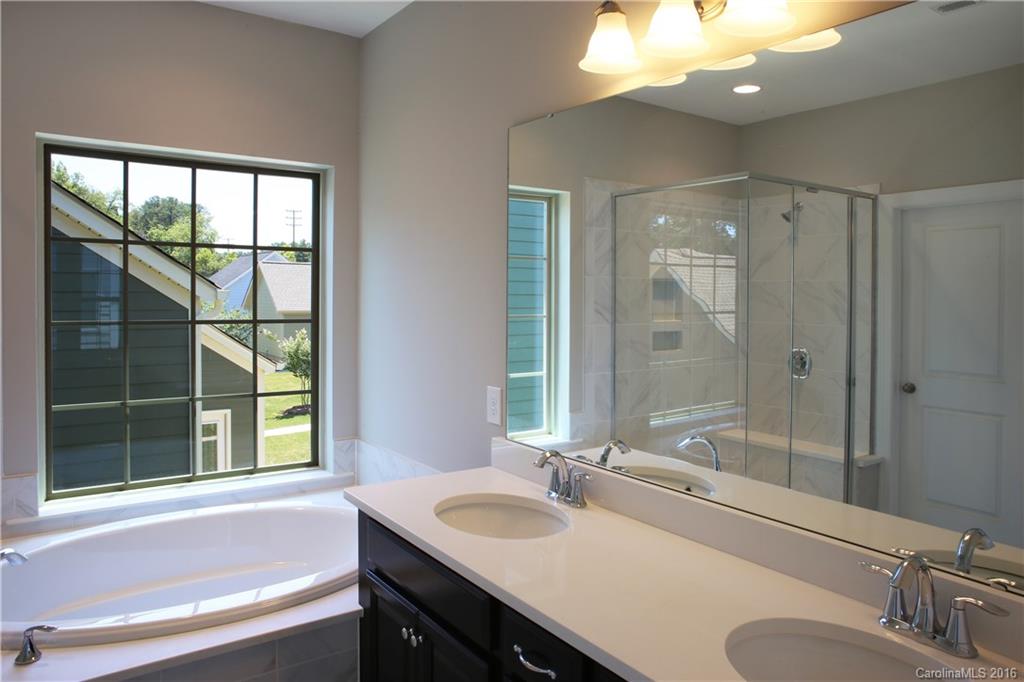 132 Helton Lane, Unit 38 Fort Mill, SC 29708 - Photo 13 of 23 a bathroom with a sink tub double vanity and a mirror