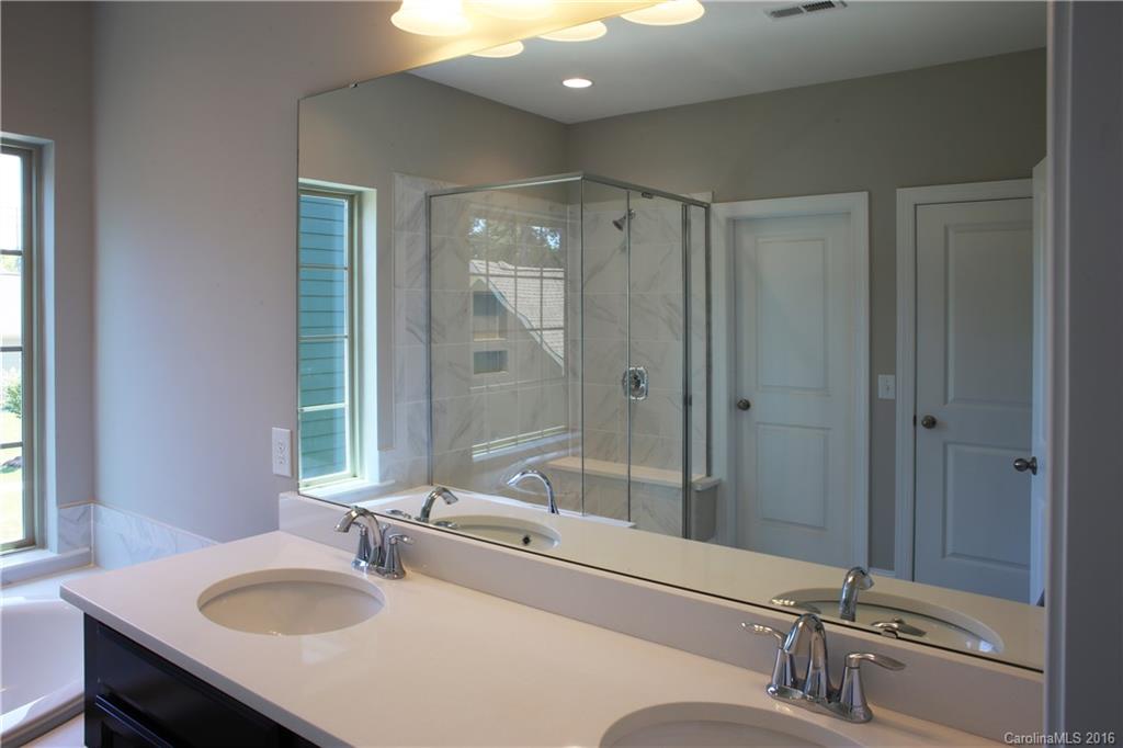 132 Helton Lane, Unit 38 Fort Mill, SC 29708 - Photo 14 of 23 a bathroom with a sink double vanity mirror and tub