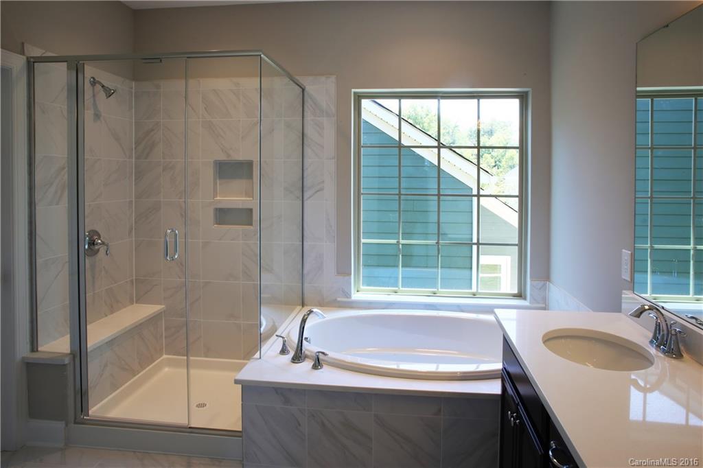 132 Helton Lane, Unit 38 Fort Mill, SC 29708 - Photo 15 of 23 a bathroom with a tub a sink a window and a shower