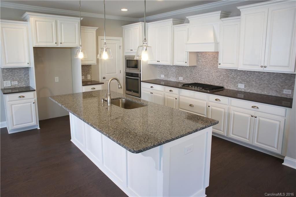 132 Helton Lane, Unit 38 Fort Mill, SC 29708 - Photo 5 of 23 a kitchen with stainless steel appliances granite countertop a sink stove and refrigerator