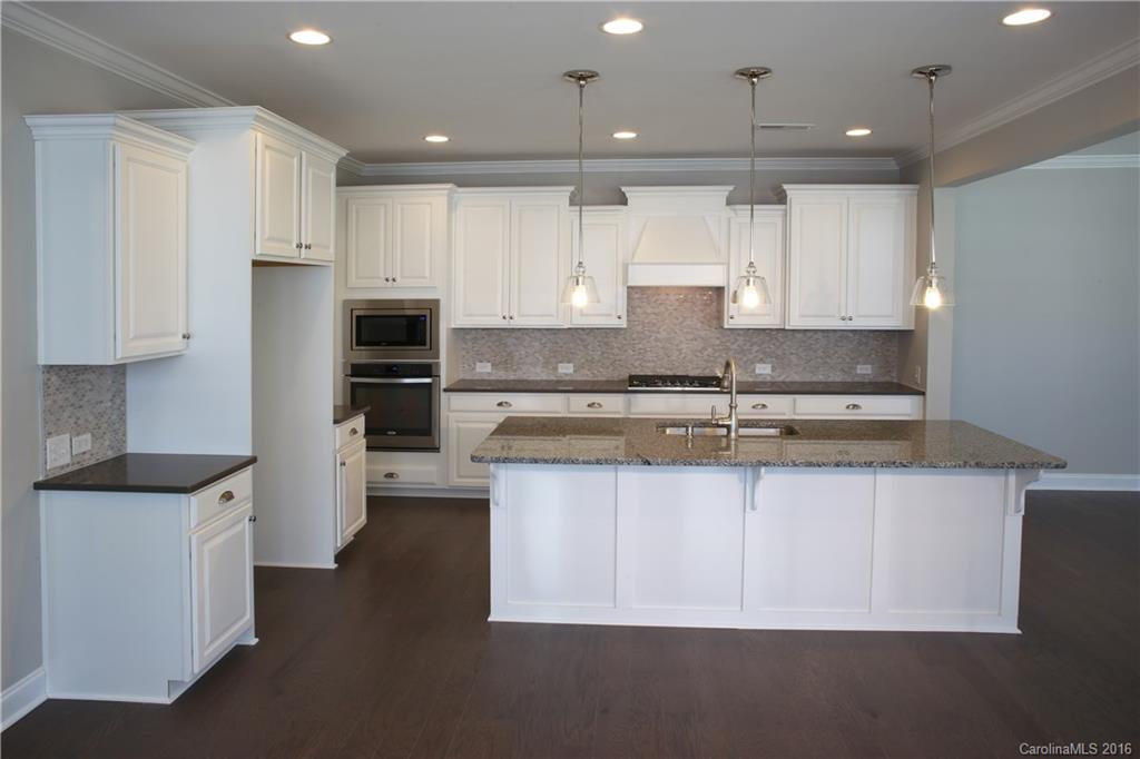 132 Helton Lane, Unit 38 Fort Mill, SC 29708 - Photo 6 of 23 a kitchen with stainless steel appliances granite countertop a sink stove and refrigerator