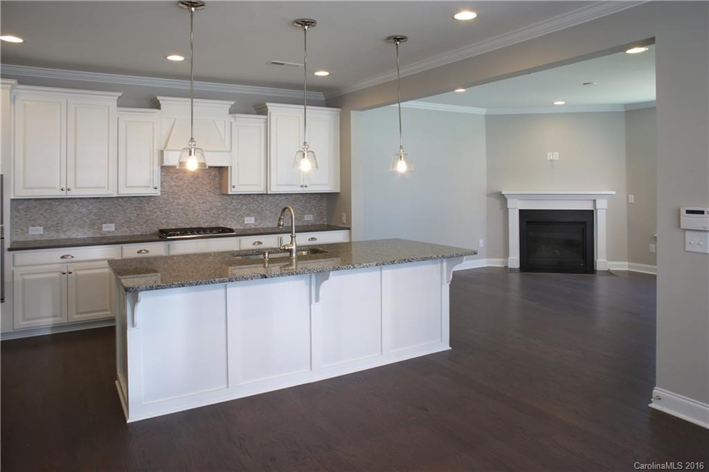 132 Helton Lane, Unit 38 Fort Mill, SC 29708 - Photo 7 of 23 a kitchen with granite countertop a stove sink and cabinets