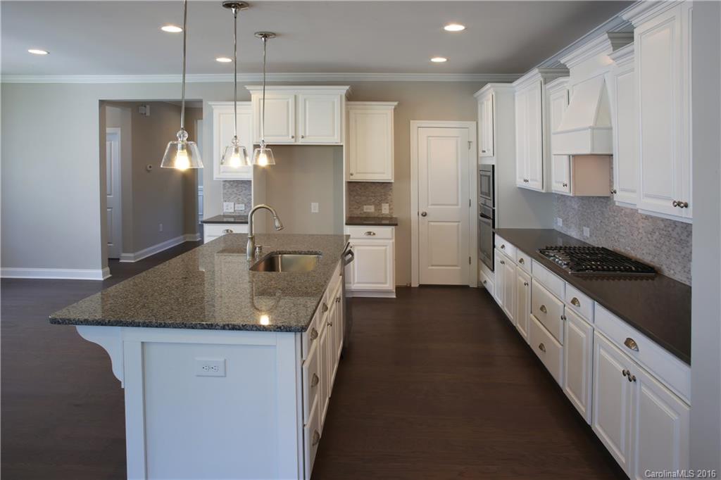 132 Helton Lane, Unit 38 Fort Mill, SC 29708 - Photo 8 of 23 a kitchen with stainless steel appliances granite countertop a sink refrigerator and cabinets